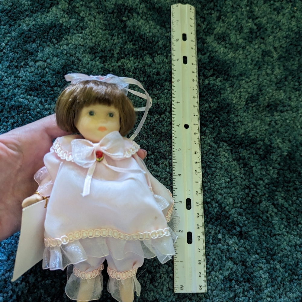 Last one. Ganz mini porcelain doll birthstone